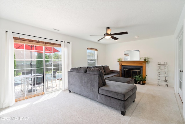 15 Tanglewood Dr, Barnegat, NJ 08005 - living room with carpet flooring, a ceiling fan, and a glass covered fireplace