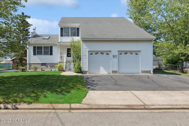 549 Clark Ave, Union Beach, NJ 07735 - traditional-style home featuring asphalt driveway, an attached garage, a front yard, and a chimney