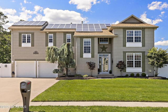 28 Hannah Lee Rd, Barnegat, NJ 08005 - view of front of home featuring concrete driveway, a front lawn, roof mounted solar panels, and a garage