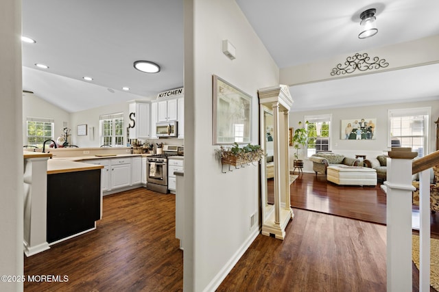 28 Hannah Lee Rd, Barnegat, NJ 08005 - kitchen featuring stainless steel appliances, dark wood-style flooring, vaulted ceiling, open floor plan, and white cabinets