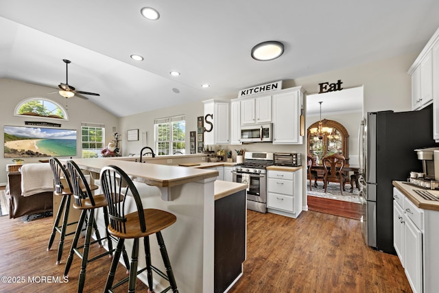 28 Hannah Lee Rd, Barnegat, NJ 08005 - kitchen featuring appliances with stainless steel finishes, ceiling fan, a breakfast bar, white cabinets, and vaulted ceiling