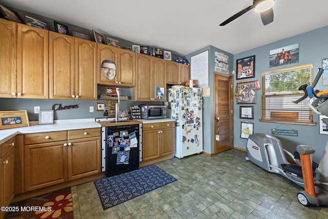 28 Hannah Lee Rd, Barnegat, NJ 08005 - kitchen with stainless steel microwave, freestanding refrigerator, ceiling fan, light countertops, and stone finish floors