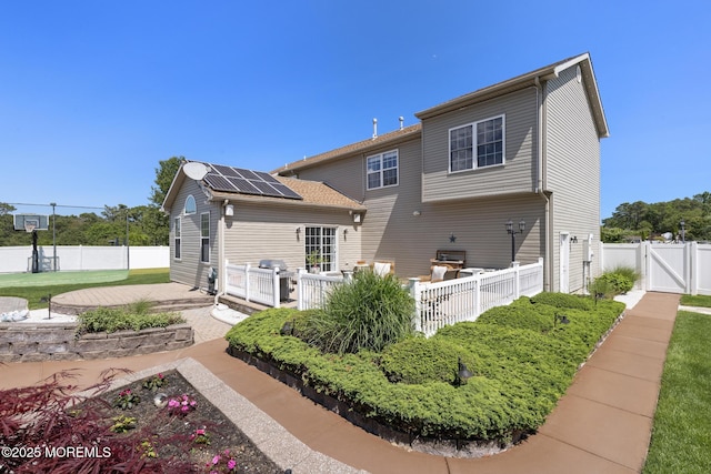 28 Hannah Lee Rd, Barnegat, NJ 08005 - rear view of house featuring a gate, solar panels, a fenced backyard, and a patio