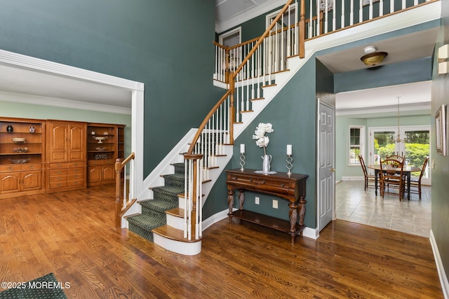 1 Yeger Dr, Upper Freehold, NJ 08501 - staircase featuring wood finished floors, baseboards, crown molding, and a high ceiling