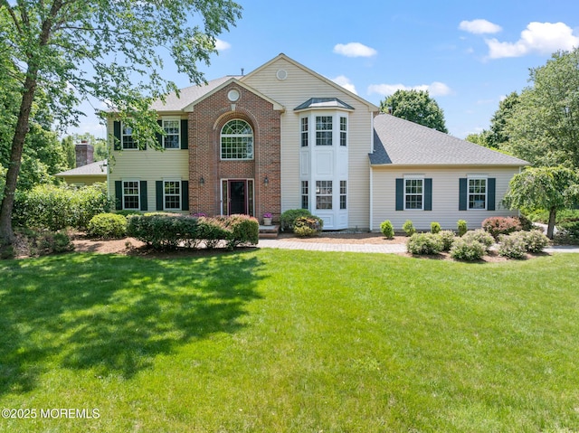 1 Yeger Dr, Upper Freehold, NJ 08501 - view of front of property with a front yard, brick siding, and roof with shingles