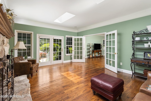 1 Yeger Dr, Upper Freehold, NJ 08501 - living area featuring french doors, a skylight, crown molding, wood finished floors, and baseboards