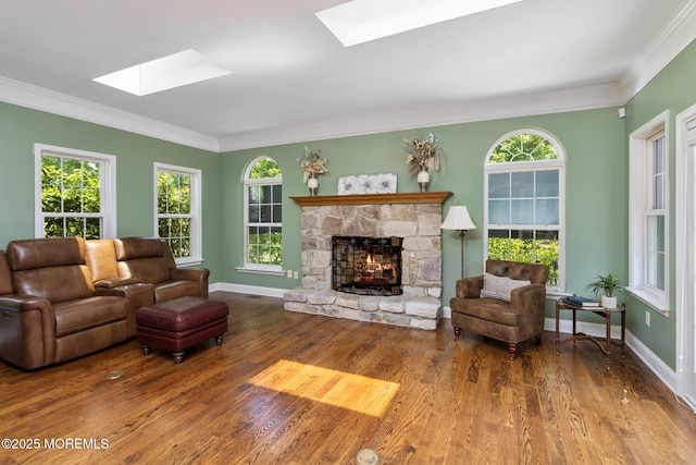 1 Yeger Dr, Upper Freehold, NJ 08501 - living area with a skylight, a fireplace, ornamental molding, wood finished floors, and baseboards