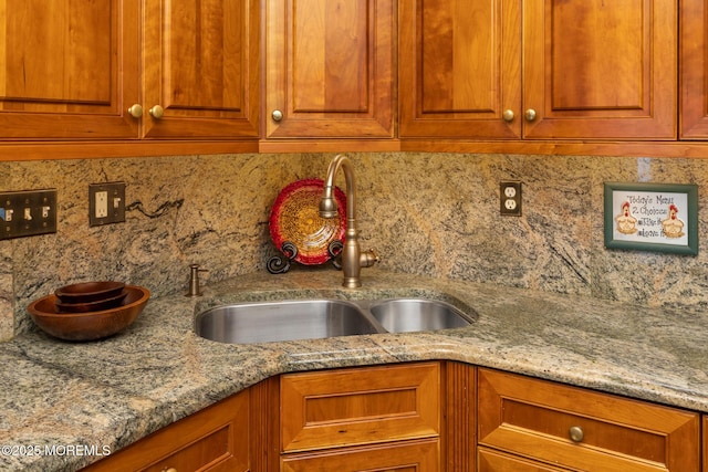 1 Yeger Dr, Upper Freehold, NJ 08501 - kitchen with a sink, backsplash, brown cabinetry, and light stone counters