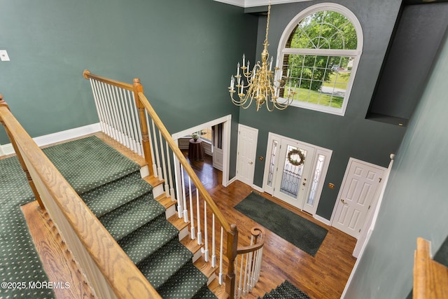 1 Yeger Dr, Upper Freehold, NJ 08501 - entrance foyer with a chandelier, wood finished floors, stairs, baseboards, and a towering ceiling