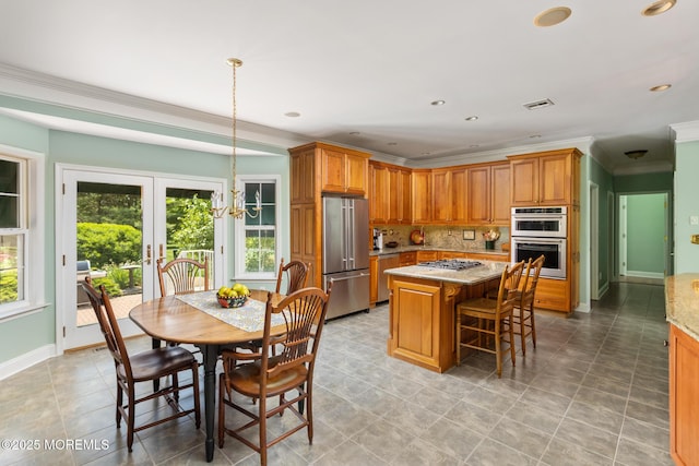 1 Yeger Dr, Upper Freehold, NJ 08501 - kitchen with appliances with stainless steel finishes, a center island, crown molding, light stone countertops, and brown cabinetry
