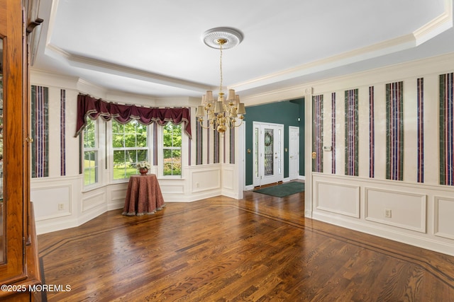 1 Yeger Dr, Upper Freehold, NJ 08501 - unfurnished dining area with a chandelier, a raised ceiling, ornamental molding, wood finished floors, and a decorative wall