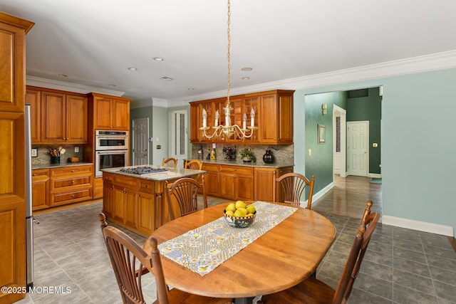 1 Yeger Dr, Upper Freehold, NJ 08501 - kitchen featuring brown cabinets, a chandelier, appliances with stainless steel finishes, backsplash, and ornamental molding