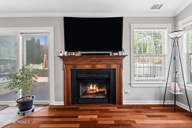34 Mount Run, Tinton Falls, NJ 07753 - detailed view of wood finished floors, ornamental molding, baseboards, and a warm lit fireplace