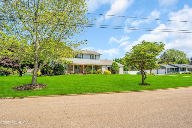 2146 Spruce Dr, Sea Girt, NJ 08750 - traditional-style house featuring an attached garage, a front lawn, and brick siding