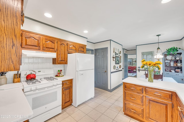 2146 Spruce Dr, Sea Girt, NJ 08750 - kitchen featuring white appliances, under cabinet range hood, light countertops, brown cabinetry, and tasteful backsplash