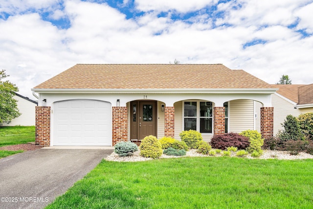 21 Turnbridge, Manchester, NJ 08759 - view of front of home featuring brick siding, asphalt driveway, a front lawn, and a garage