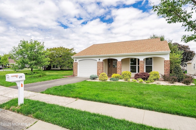 21 Turnbridge, Manchester, NJ 08759 - view of front facade with brick siding, driveway, an attached garage, and a front yard