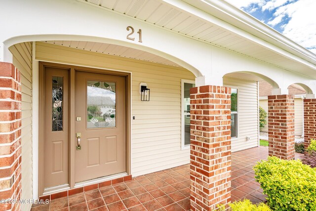 21 Turnbridge, Manchester, NJ 08759 - doorway to property featuring a porch and brick siding
