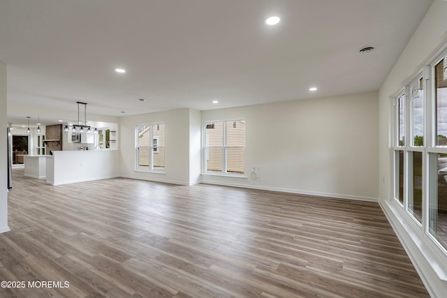 21 Turnbridge, Manchester, NJ 08759 - unfurnished living room with light wood-style flooring, baseboards, a chandelier, and recessed lighting