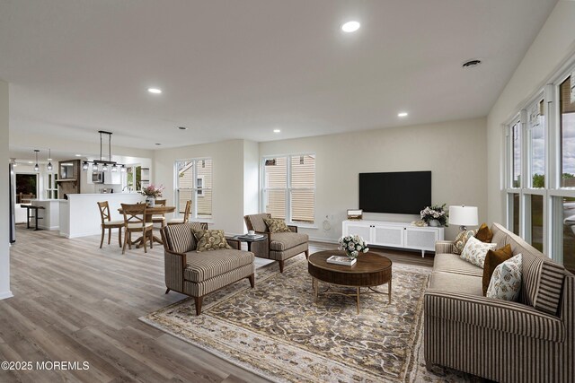 21 Turnbridge, Manchester, NJ 08759 - living room with wood finished floors, recessed lighting, baseboards, and a chandelier