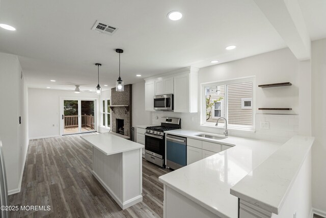 21 Turnbridge, Manchester, NJ 08759 - kitchen featuring a sink, stainless steel appliances, decorative backsplash, open shelves, and recessed lighting