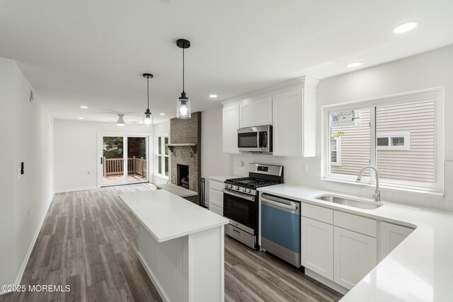 21 Turnbridge, Manchester, NJ 08759 - kitchen featuring stainless steel appliances, a sink, wood finished floors, white cabinets, and recessed lighting