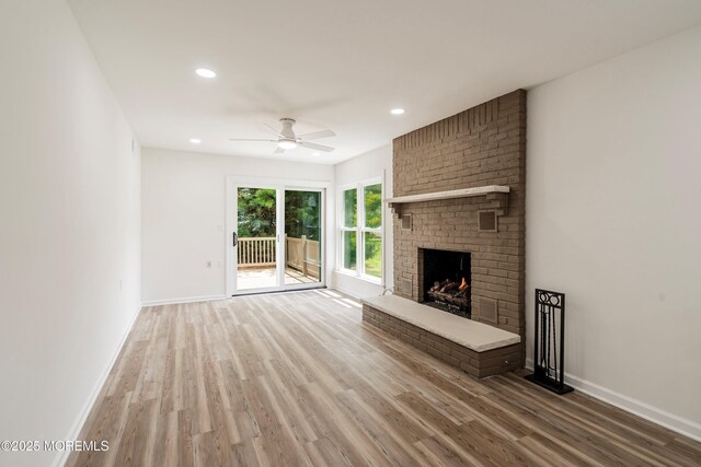 21 Turnbridge, Manchester, NJ 08759 - unfurnished living room featuring wood finished floors, a brick fireplace, a ceiling fan, baseboards, and recessed lighting