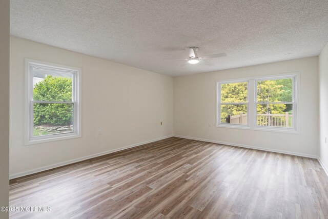 21 Turnbridge, Manchester, NJ 08759 - empty room featuring wood finished floors, ceiling fan, baseboards, and a textured ceiling