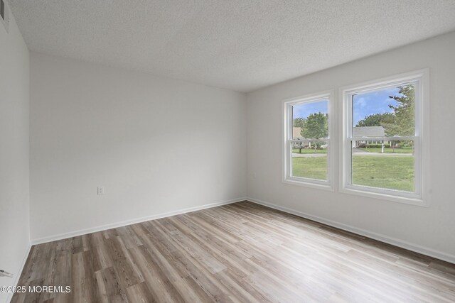 21 Turnbridge, Manchester, NJ 08759 - empty room featuring wood finished floors, a textured ceiling, and baseboards
