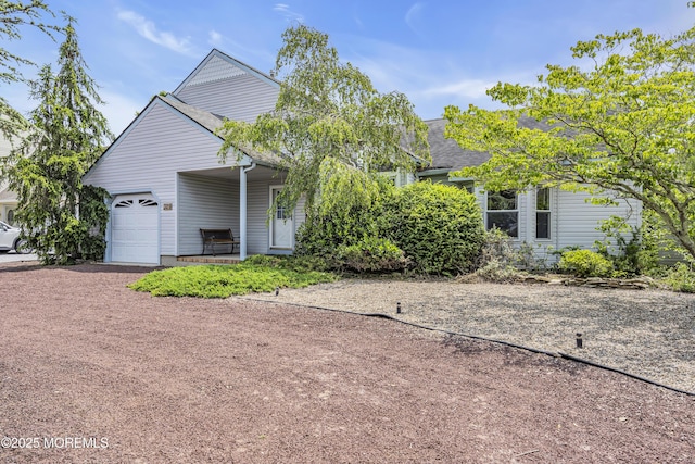 329 Jennings Rd, Manahawkin, NJ 08050 - view of property hidden behind natural elements with a garage, dirt driveway, covered porch, and roof with shingles