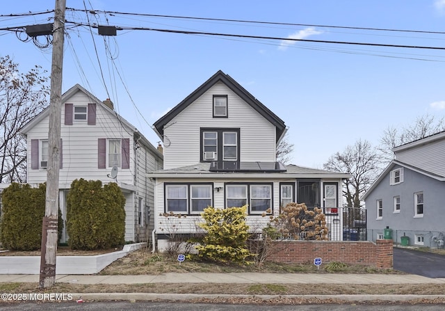 1952 Stratford Ave, Neptune Township, NJ 07753 - view of front of home featuring a shingled roof and solar panels
