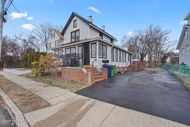 1952 Stratford Ave, Neptune Township, NJ 07753 - view of home's exterior with a chimney and driveway