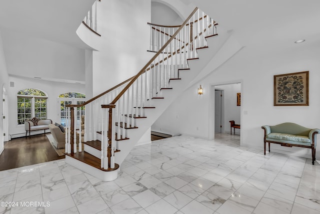 34 Bruns Rd, West Allenhurst, NJ 07711 - stairs featuring a towering ceiling, marble finish floors, baseboard heating, recessed lighting, and baseboards