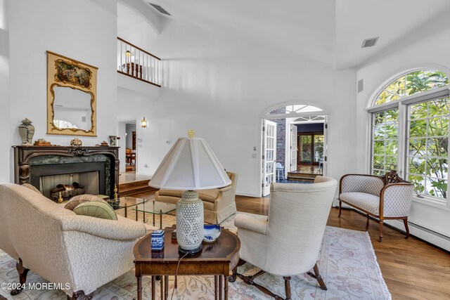 34 Bruns Rd, West Allenhurst, NJ 07711 - living area with a high ceiling, a high end fireplace, healthy amount of natural light, and wood finished floors