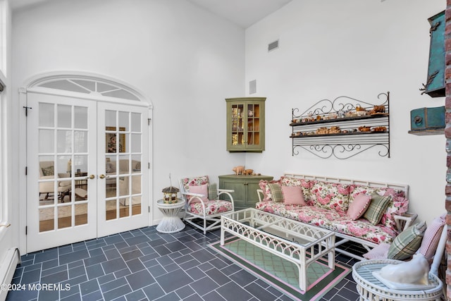 34 Bruns Rd, West Allenhurst, NJ 07711 - living room with a towering ceiling, french doors, dark tile patterned floors, and baseboard heating