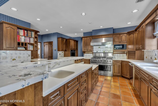 34 Bruns Rd, West Allenhurst, NJ 07711 - kitchen featuring appliances with stainless steel finishes, wall chimney range hood, a sink, open shelves, and backsplash