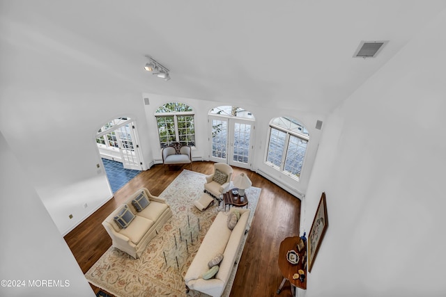 34 Bruns Rd, West Allenhurst, NJ 07711 - living area featuring wood finished floors, vaulted ceiling, baseboards, and french doors