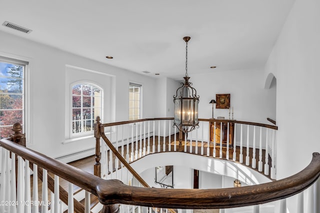 34 Bruns Rd, West Allenhurst, NJ 07711 - stairway with a chandelier, arched walkways, and wood finished floors