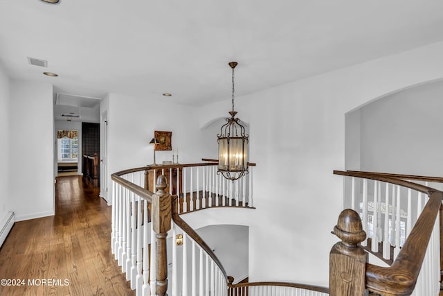 34 Bruns Rd, West Allenhurst, NJ 07711 - hall with an upstairs landing, a chandelier, wood finished floors, arched walkways, and baseboards
