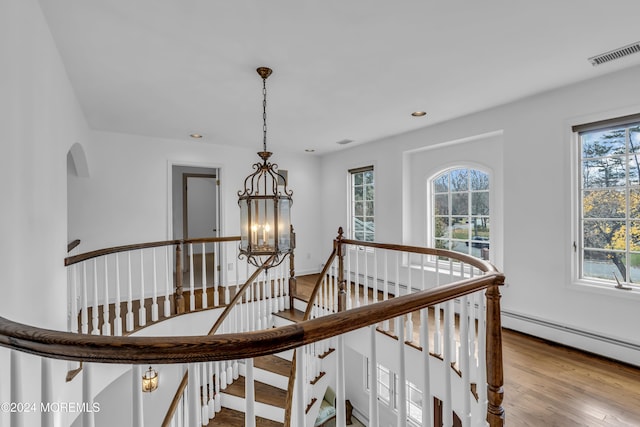 34 Bruns Rd, West Allenhurst, NJ 07711 - staircase featuring healthy amount of natural light, a chandelier, wood finished floors, recessed lighting, and baseboards