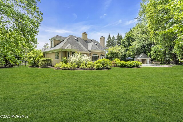 34 Bruns Rd, West Allenhurst, NJ 07711 - view of front of home with a front yard, a chimney, and stucco siding