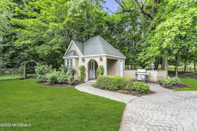 34 Bruns Rd, West Allenhurst, NJ 07711 - view of front of property featuring stucco siding and an outbuilding