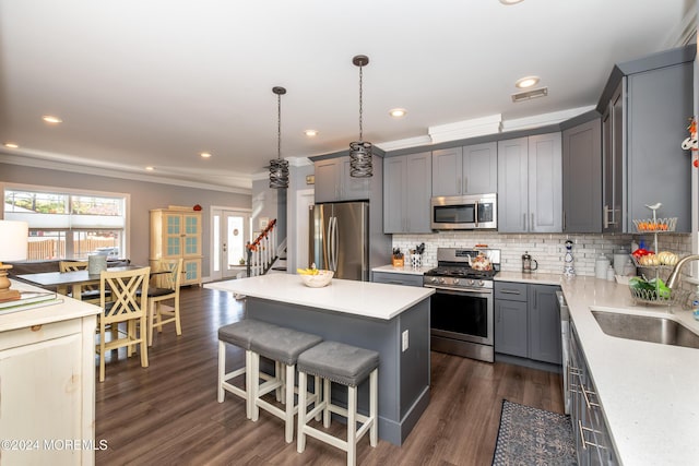 1608 Champlain St, Toms River, NJ 08757 - kitchen featuring appliances with stainless steel finishes, a sink, gray cabinets, tasteful backsplash, and a kitchen island