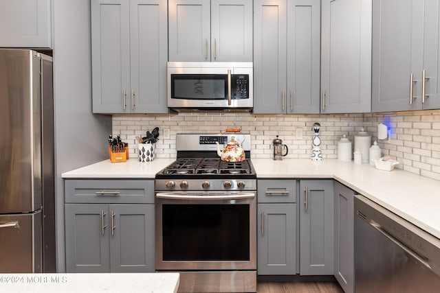 1608 Champlain St, Toms River, NJ 08757 - kitchen featuring appliances with stainless steel finishes, gray cabinets, backsplash, and light countertops