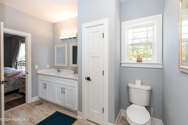 1608 Champlain St, Toms River, NJ 08757 - ensuite bathroom with double vanity, wood finished floors, toilet, and baseboards