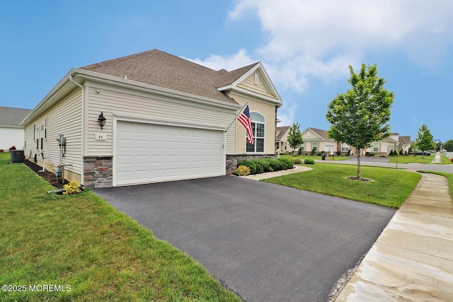 46 Rockland St, Barnegat, NJ 08005 - view of front of home featuring driveway, a garage, stone siding, a front lawn, and central AC