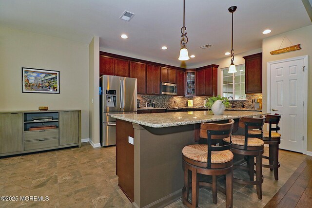 46 Rockland St, Barnegat, NJ 08005 - kitchen with stainless steel appliances, backsplash, a kitchen island, glass insert cabinets, and pendant lighting