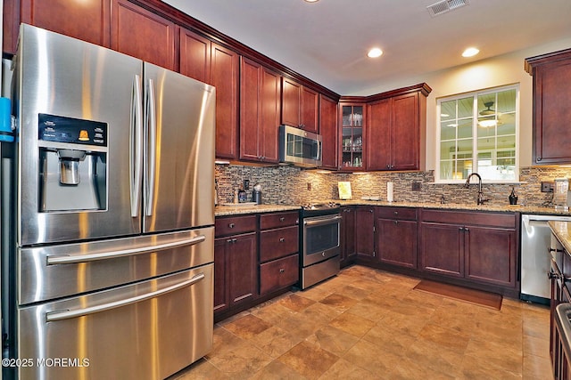 46 Rockland St, Barnegat, NJ 08005 - kitchen featuring stainless steel appliances, a sink, backsplash, light stone countertops, and recessed lighting