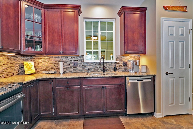 46 Rockland St, Barnegat, NJ 08005 - kitchen with stainless steel appliances, reddish brown cabinets, a sink, light stone counters, and decorative backsplash