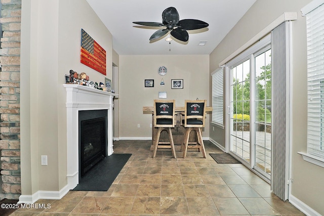 46 Rockland St, Barnegat, NJ 08005 - dining area featuring a fireplace with flush hearth, a ceiling fan, baseboards, and stone finish floors